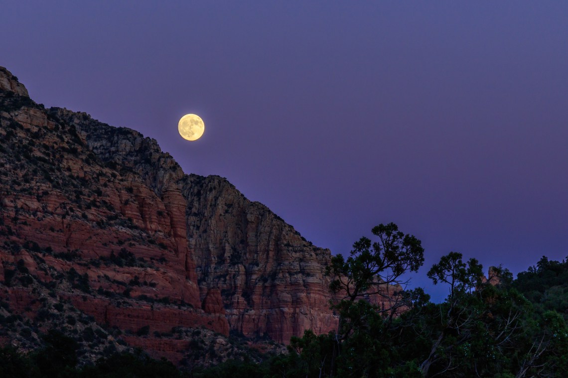Moonrise at sunset over the red rock of