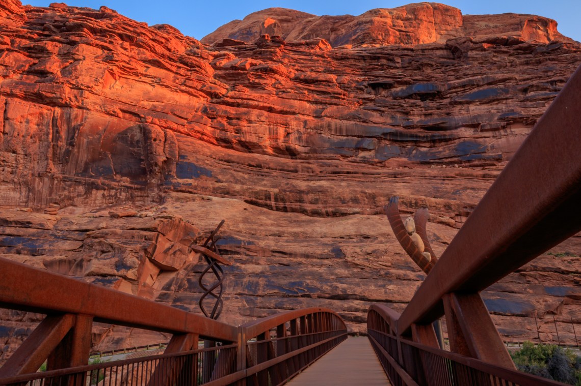 Sunrise lights up the cliffs above the pedestrian / cyclist brid